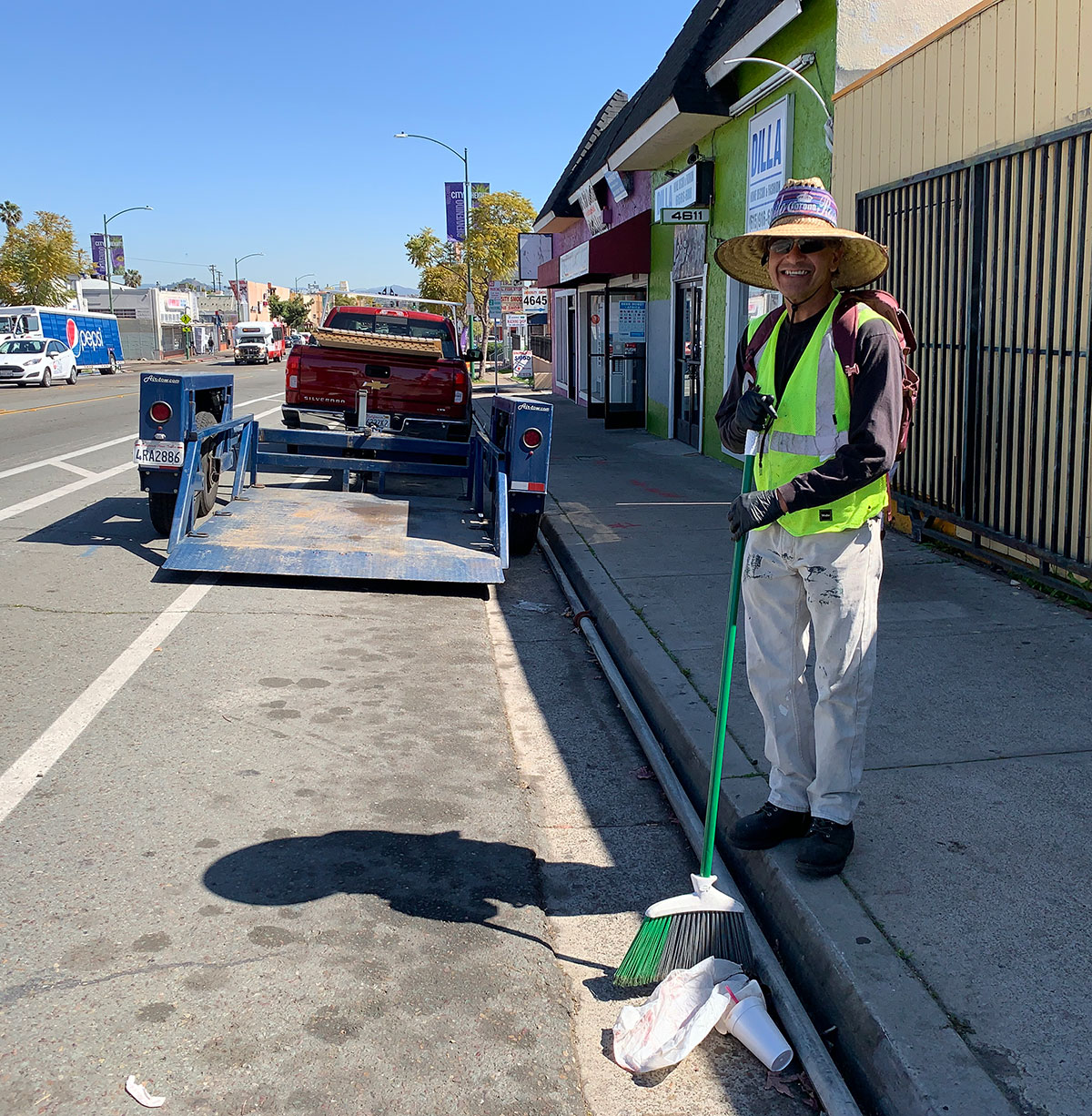 City Heights Business Association Clean & Safe maintenance worker sweeping up trash