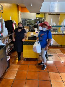City Heights residents receive a free meal from Super Cocina