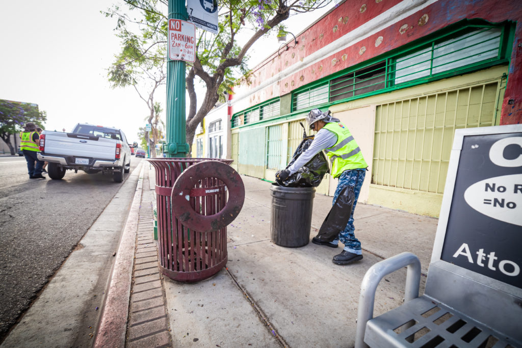 City Heights Business Association clean and safe crew removing trash and replacing trash linings on University Ave in City Heights, San Diego