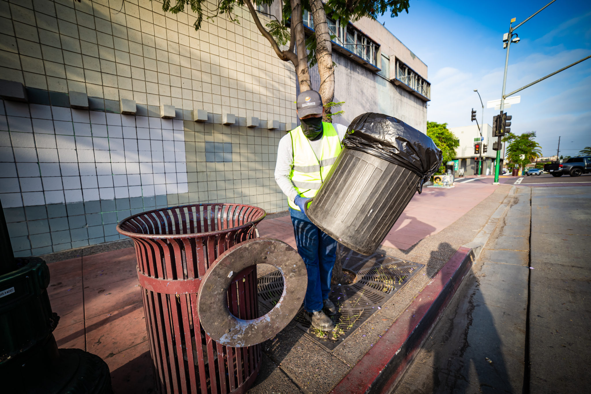 CHBA Clean & Safe crew member emptying trash bin