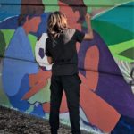 Artist working on the Teralta Park Unity in Community Mural