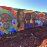 Portion of Teralta Park Unity mural featuring faces of people who reside in the city heights community.