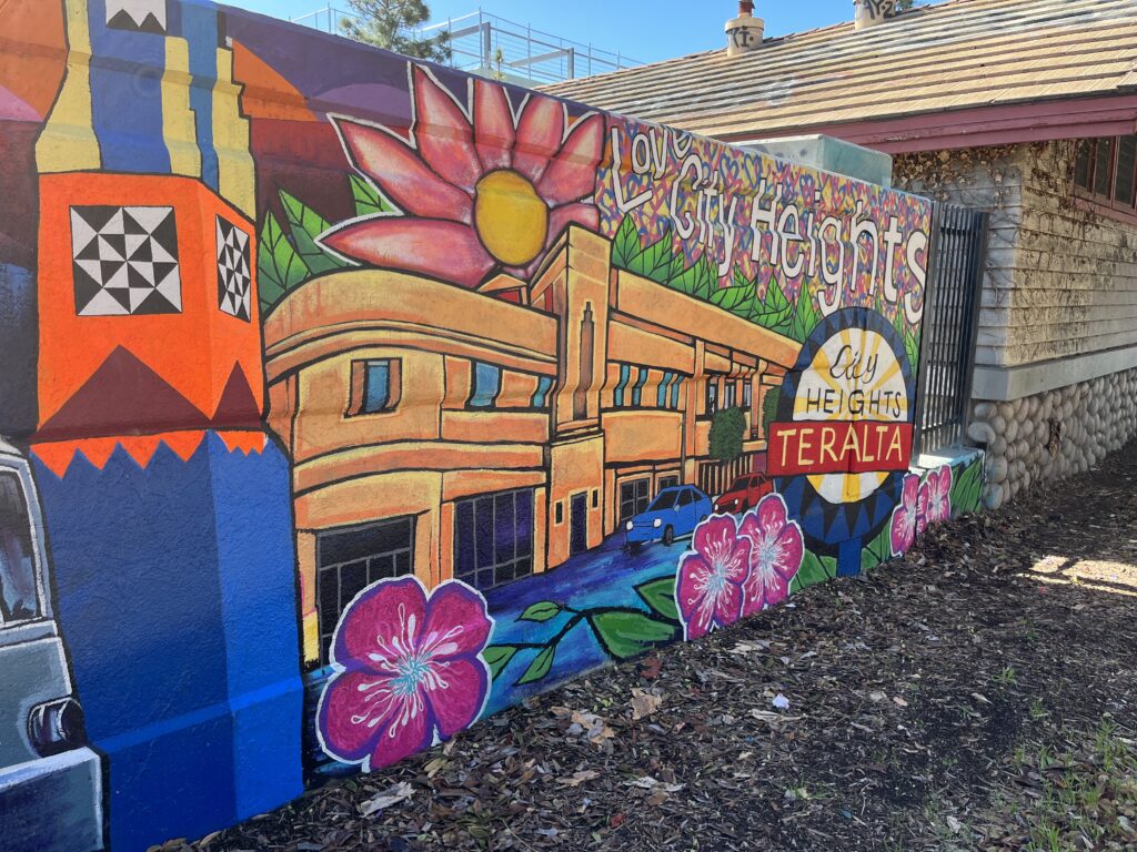 Portion of Teralta Park Unity mural featuring representations of the Tower Bar, iconic Egyptian Garage, Love City Heights mural, and Teralta Neighborhood sign.