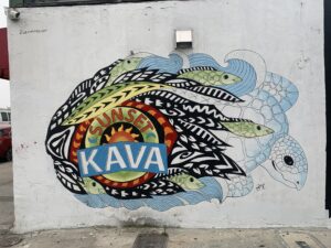 Colorful urban wall mural depicting a sea turtle and fish.