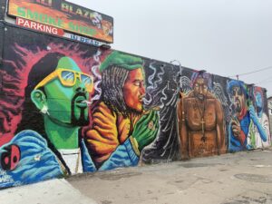 Colorful urban wall mural depicting famous musicians.