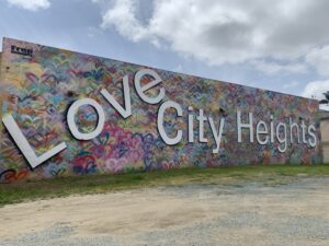 Colorful urban wall mural depicting the phrase "Love City Heights"