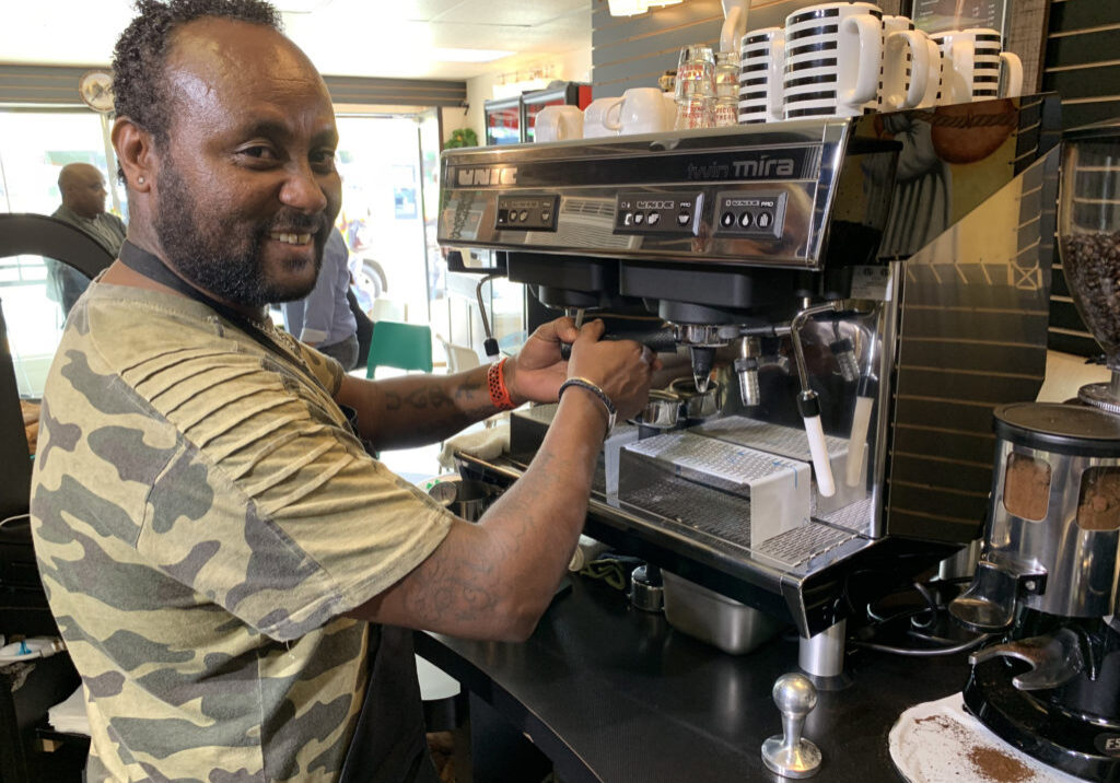 Local City Heights business owner working in a coffee shop
