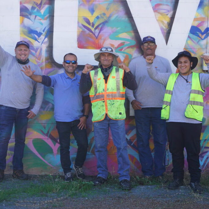 CHBA Clean Up Crew in front of Love City Heights mural